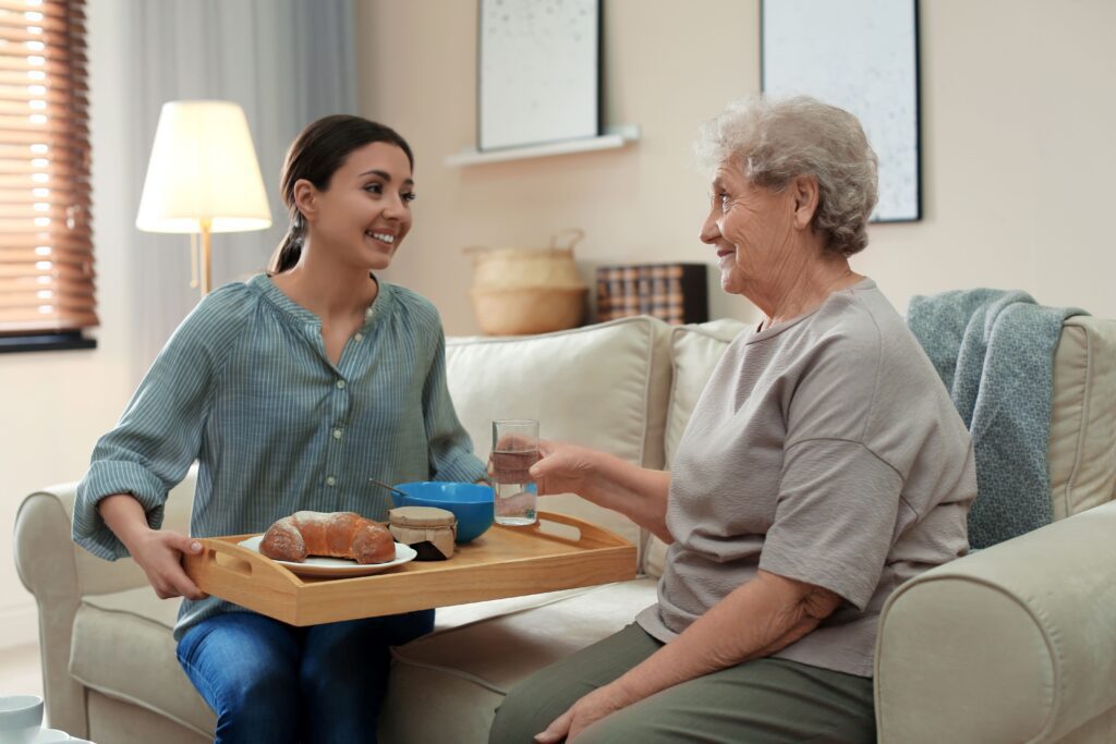Carer at home helping resident