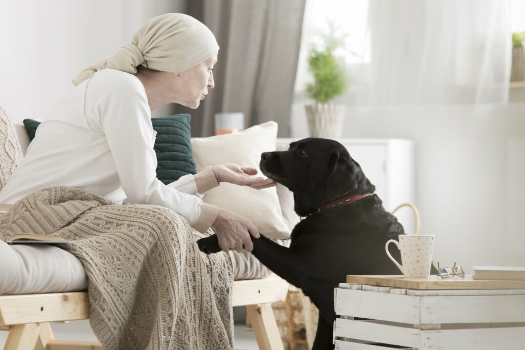 patient petting her dog during pet therapy